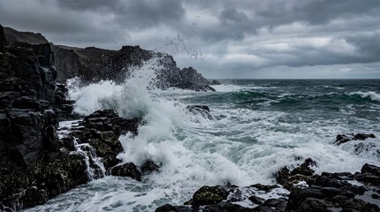 Fototapeta premium Storm waves crash against black volcanic rocks beneath heavy clouds on a rugged coast, conveying raw ocean power for travel, weather, or nature conservation campaigns.