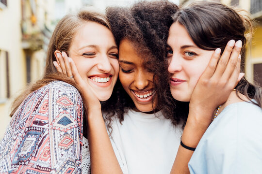 Smiling woman embracing friends
