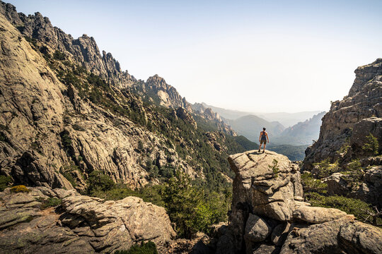 Female hiker standing on viewpoint, Aiguilles de Bavella, Corsica, France