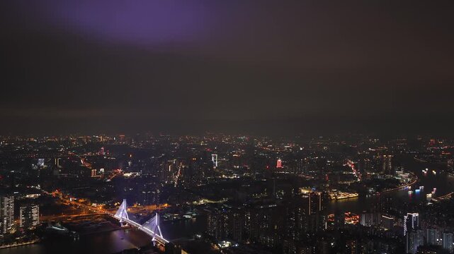 Aerial night view illuminated modern city skyline with skyscrapers buildings and river. Urban architecture, business center scenery night. Metropolitan landscape glowing lights. Twilight town travel.