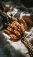 Obraz premium Minimalist Harvest Composition Featuring Dried Wheat Bundles On A Textured Neutral Beige Surface