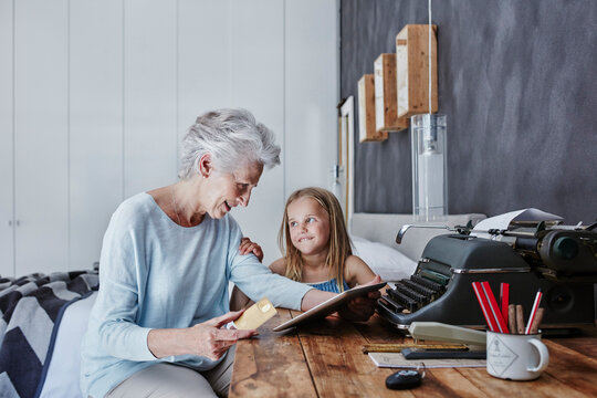 Grandmother and granddaughter shopping online at home