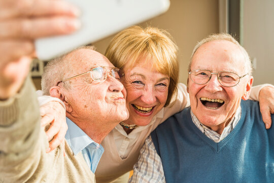 Cheerful seniors taking selfie