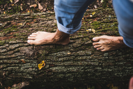 Man walking on wooden log