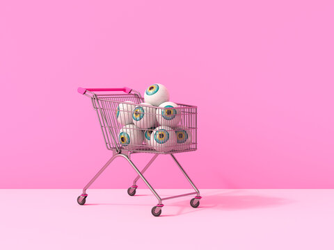 A shopping cart contains eyeball spheres on a pink background