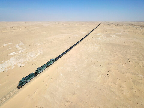 Mauritania, Nouadibou, Aerial view of cargo train riding through desert