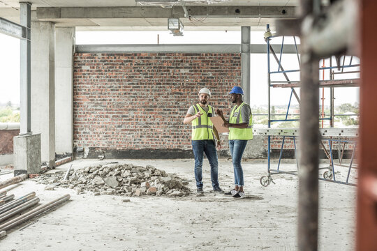 Construction workers discussing in construction site
