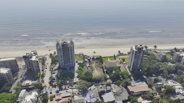 Mumbai skyline overlooking Versova Beach during golden hour aerial view,
Urban skyline and Versova Beach during sunset in Mumbai India

