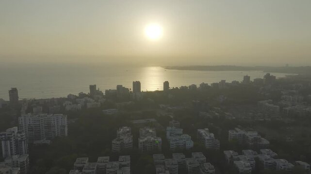 Aerial drone view of Versova Beach at sunset with Mumbai skyline India,
Golden hour aerial panorama of Versova Beach Mumbai Maharashtra

