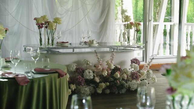 Beautifully decorated wedding reception table features floral arrangements and glassware, creating an inviting atmosphere for guests to enjoy