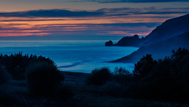Finisterre Sunset in Galicia, Spain. Mar de Fora beach and Nave cape in Costa da Morte.