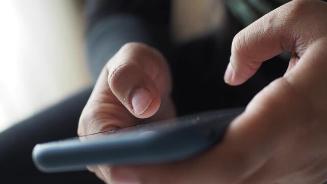 Close-up of hands scrolling on smartphone screen modern technology and communication