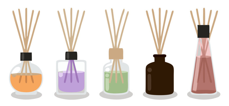 Assorted reed diffusers with colored liquids in clear and opaque bottles against white background