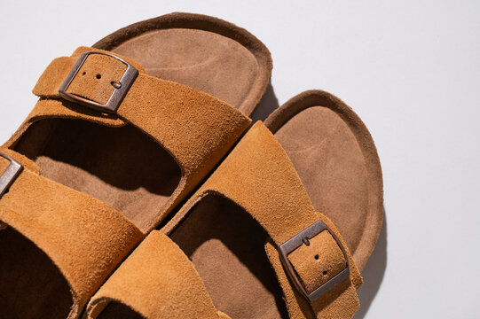 Classic brown sandals in macro view feature suede finish, sturdy sole and adjustable straps. Summer footwear delivers comfort, versatile styling and natural aesthetic for business and retail use.