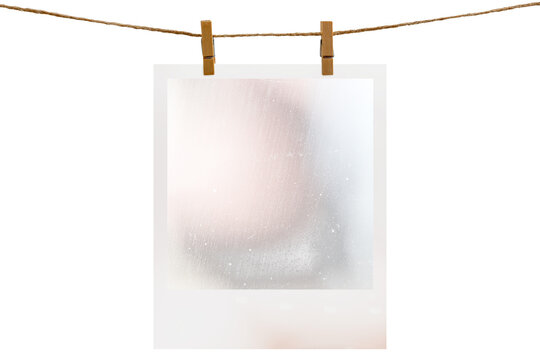 Blank photo frame hanging on a rope with a wooden clothespin. Isolated transparent PNG mockup.