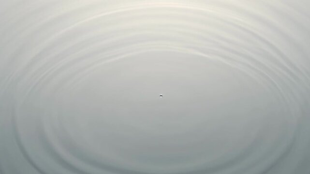 Water surface ripple effect from single drop impact on grey background wave splash circle liquid abstract wave splash circle liquid