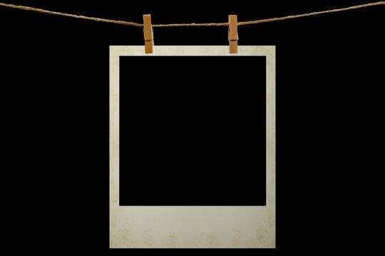 Blank photo frame hanging on a rope with a wooden clothespin. Isolated black JPEG mockup.