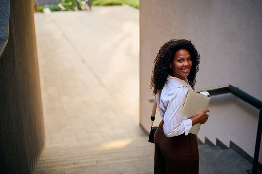 African American Professional Woman Smiling On Urban Stairs With Laptop And Coffee, Business Lifestyle