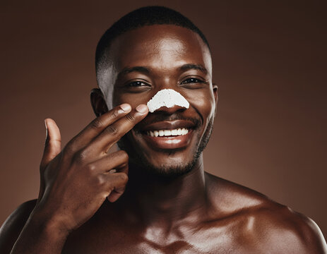 Smiling Black Man Applying White Nose Pore Strip for Clear Skin Routine