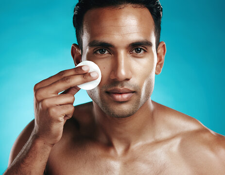 Handsome Man Using a Cotton Pad for Facial Skincare and Healthy Glowing Skin