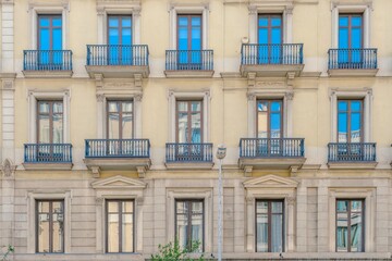 Fototapeta premium Classic Yellow Residential Building Facade, Symmetrical, Urban Architecture, Barcelona