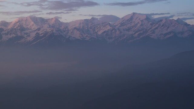 Dayara Bugyal Uttarakhand India. Bandarpoonch, Draupadi Ka Danda and other Gangotri Glacial Peaks. Snowy mountain peaks above layered blue hills