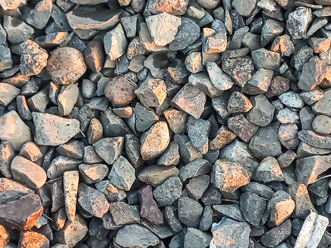 Top view of grey and brown crushed stone ballast background