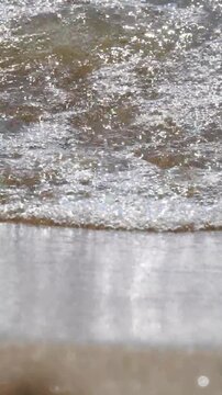 Sea waves splashing on sunny day, vertical video