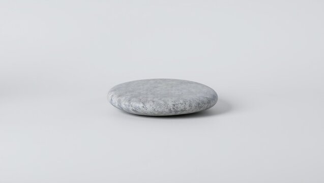 Single grey smooth river stone on a flat surface