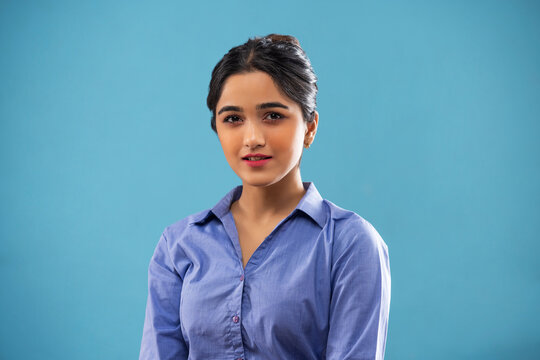 Young girl in formal outfit posing in front of camera