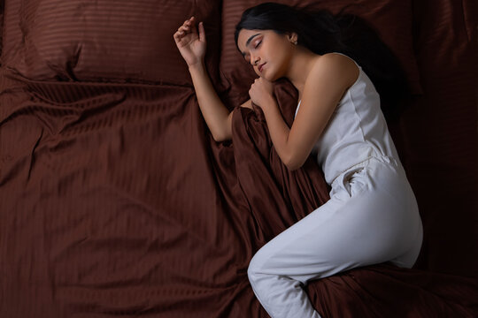Portrait of a young girl sleeping on bed