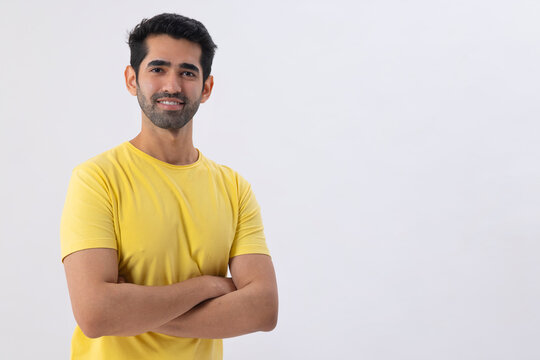 Portrait of a young man standing in front of camera with hands crossed