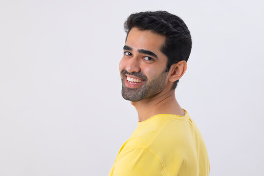 Portrait of a happy young man looking back at the camera