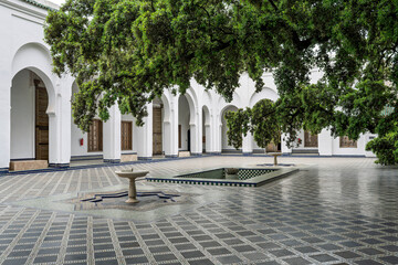 Obraz premium Courtyard with Arcades and Overhanging Trees at the Batha House, Fes, Morocco