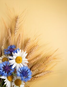 Bunch of flowers: blue coneflowers, daisies and yellow wheat ears on pale yellow background with copy space