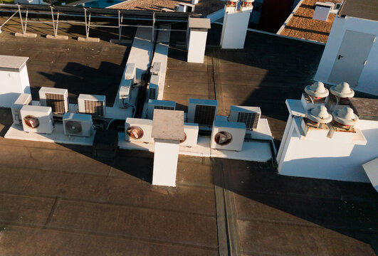 Dual inverter compressor, combination of air conditioner compressor and heating pump, installed on a roof of family house 