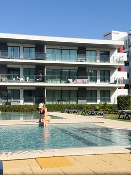 Woman enjoys a relaxing summer vacation by the pool