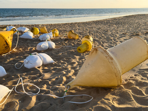 buoys with weights on the ocean shore