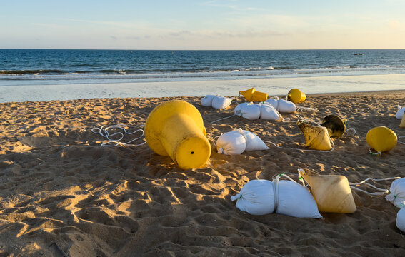A lot of garbage bags, trash, waste, rubbish on the sand of the beach littering the nature. Environmental concept.