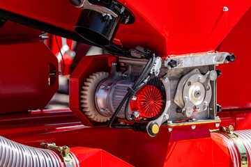 Fototapeta premium Agricultural seeder electric drive motor with precision metering unit. Modern farming planter dispenser mechanism closeup view with spur gear and smart technical electronic details for tractor.
