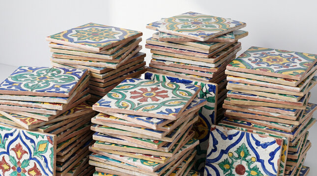 Traditional painted ceramic tiles with ornamental patterns stacked  