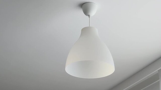 White ordinary plastic ceiling lamp shown from different angles in a room during daylight hours