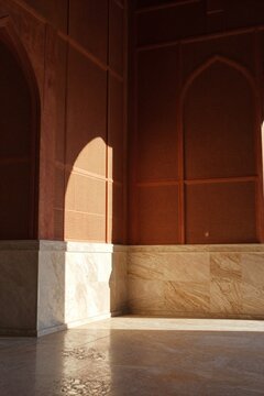 Modern Minimalist Mihrab Interior Terracotta Walls Sunlight Shadows on Marble Floor Background with Copy Space