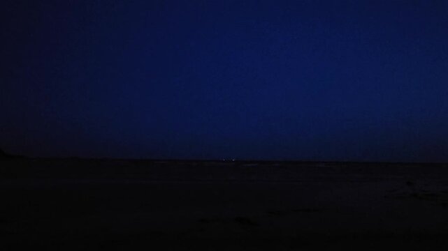 dark blue sky,Dark sky looms over silent, empty horizon. Distant light glows faintly, barely visible. Night air feels still, heavy, and deep. Perfect for mood, solitude, or mystery themes. No people, 
