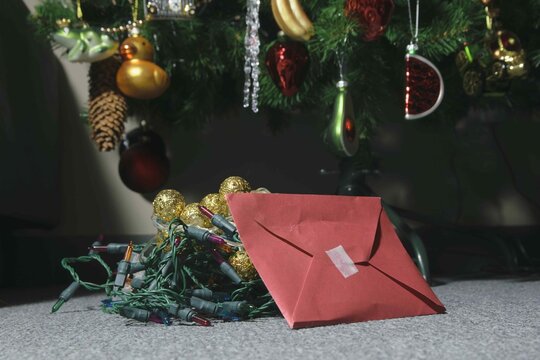 Brightly wrapped gifts and colorful decorations under a tree during the holiday season