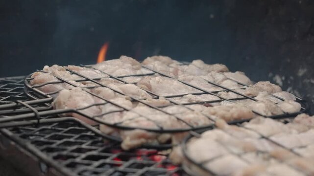 Fresh marinated meat grilling over hot charcoal and open flame