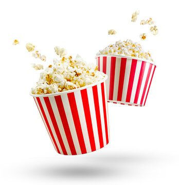 Popcorn in red and white striped box and flying out grains isolated on white or transparent background