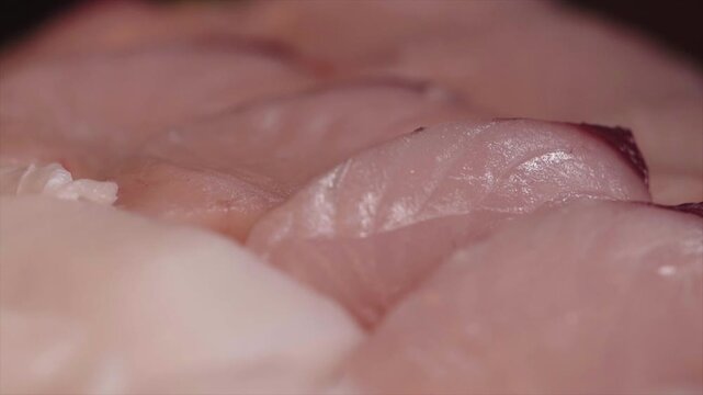 Macro shot of freshly sliced Spanish mackerel sashimi showing fine texture