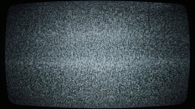 Close-up view of a vintage television screen displaying classic analog static or 'snow' with a grainy, noisy texture.