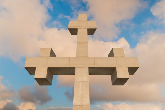 Front view of huge stone cross monument against warm white clouds, located on the mountain over Gonio town near Batumi, Georgia. Christianity, spiritual, religion, Orthodoxy and cloudscape concept